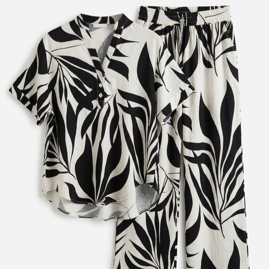Conjunto de dos piezas fluido estampado de hojas tropicales con camisa de manga corta abotonada y pantalón largo de pernera amplia con cintura elástica