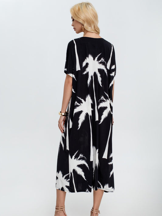 Vestido estampado tropical con escote en V y manga corta amplia, corte fluido oversize estilo elegante casual con tejido ligero ideal para verano